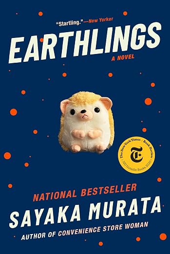 A stuffed hedgehog toy amongst a dark blue background with orange polka-dots