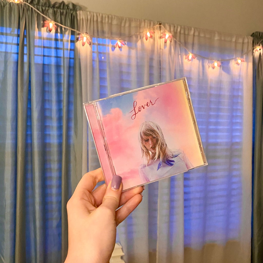 Girl holding Taylor Swift\'s Lover album.