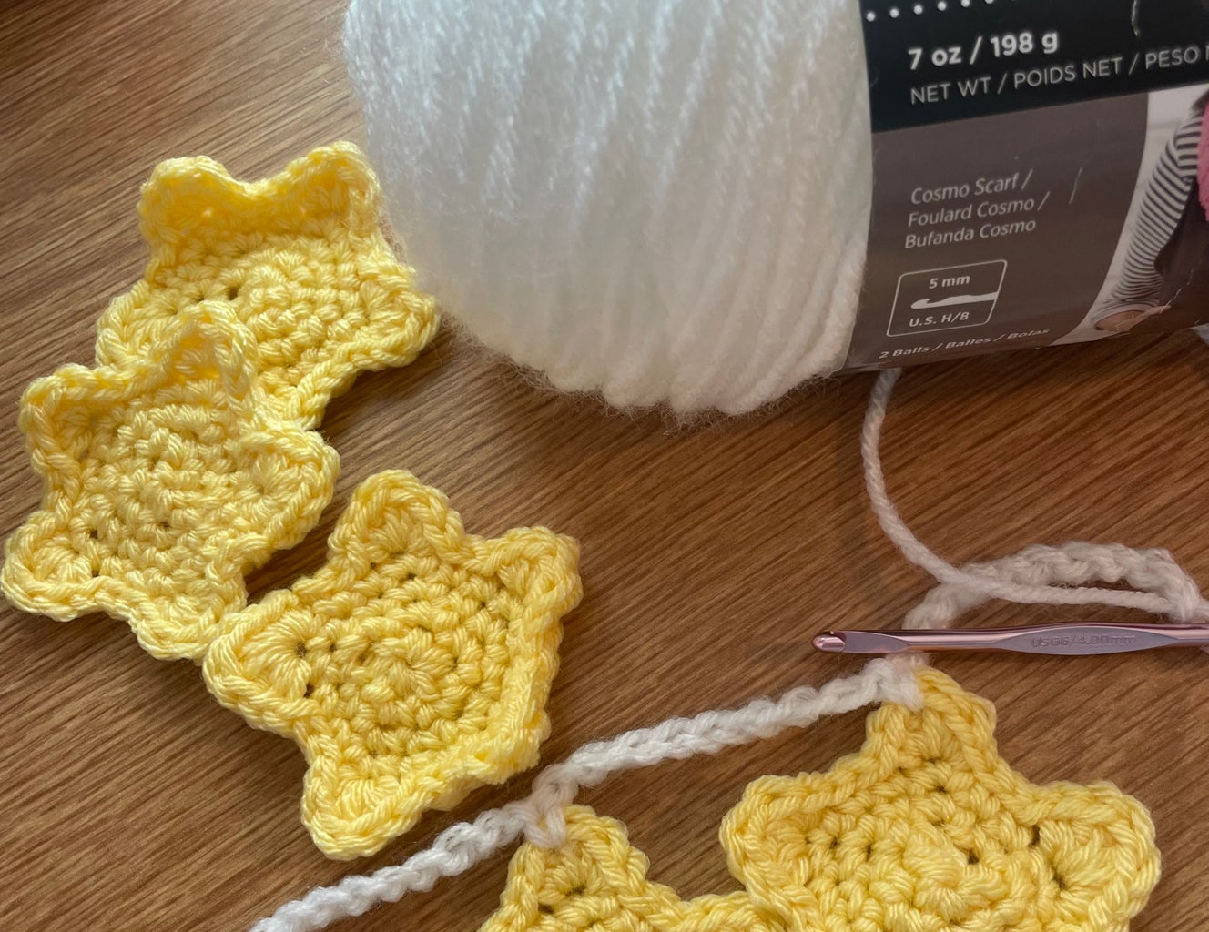yellow crocheted stars and white yarn