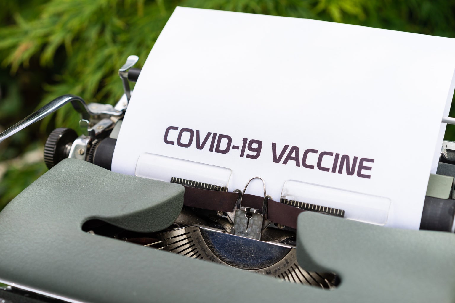 \"COVID-19 VACCINE\" typed on paper in a typewriter