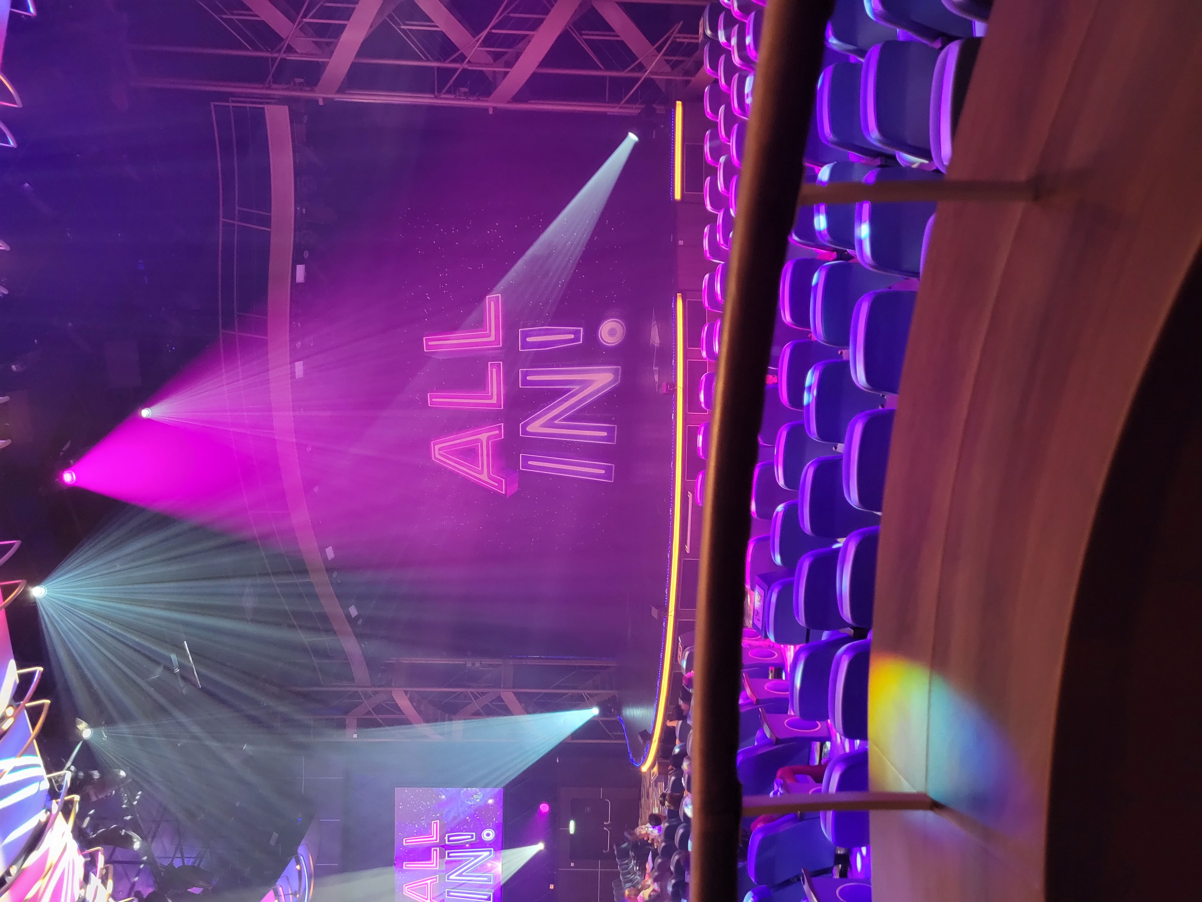 A balcony seat viewing of an emoty stage with the show title of \