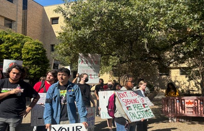 A group of people holding various signs advocating for Palestine, gathered at the Stallions statue, Wednesday, Nov. 13 at Texas State University.