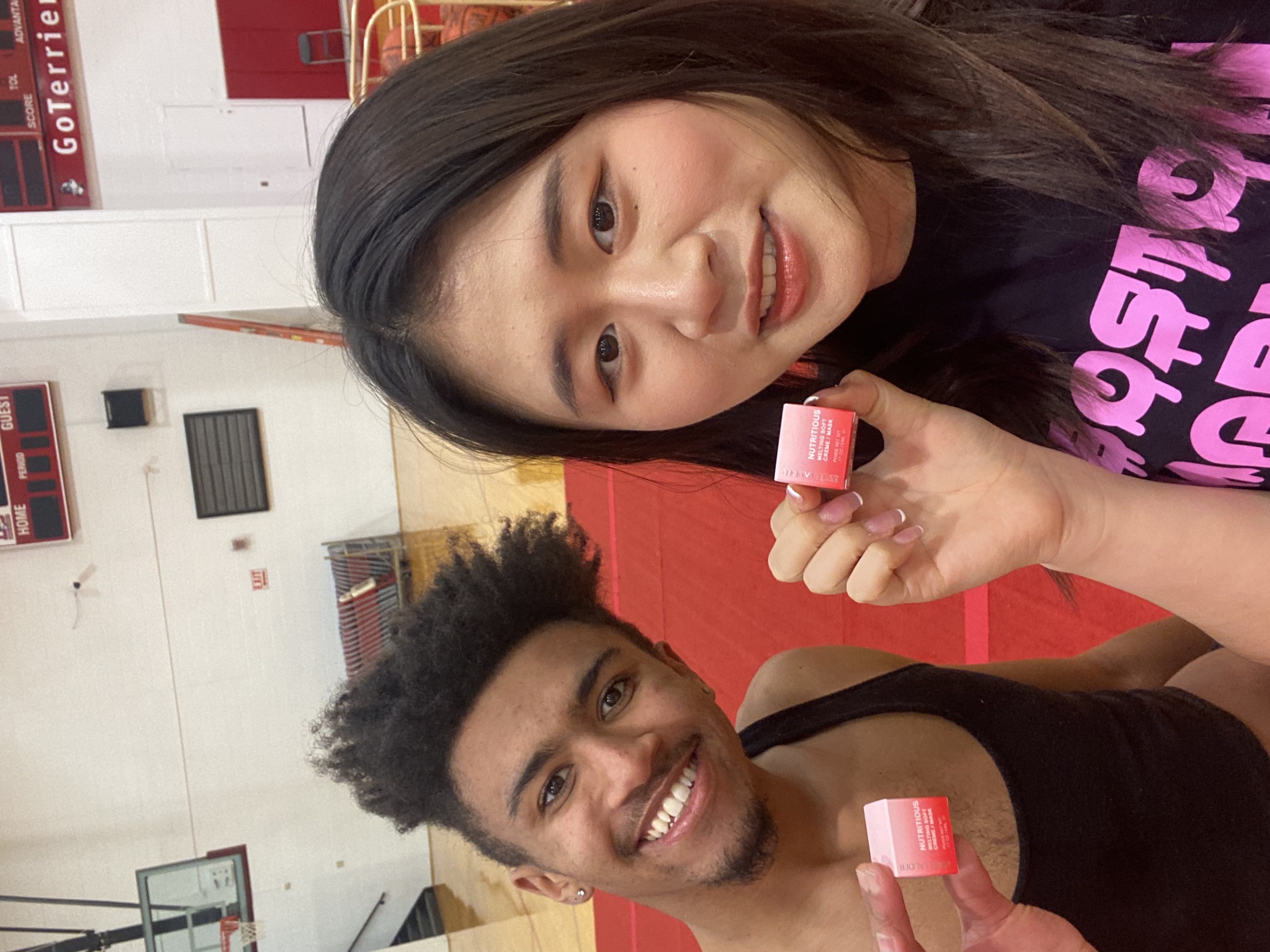 Cheerleaders Holding Estée Lauder Nutritious Skincare