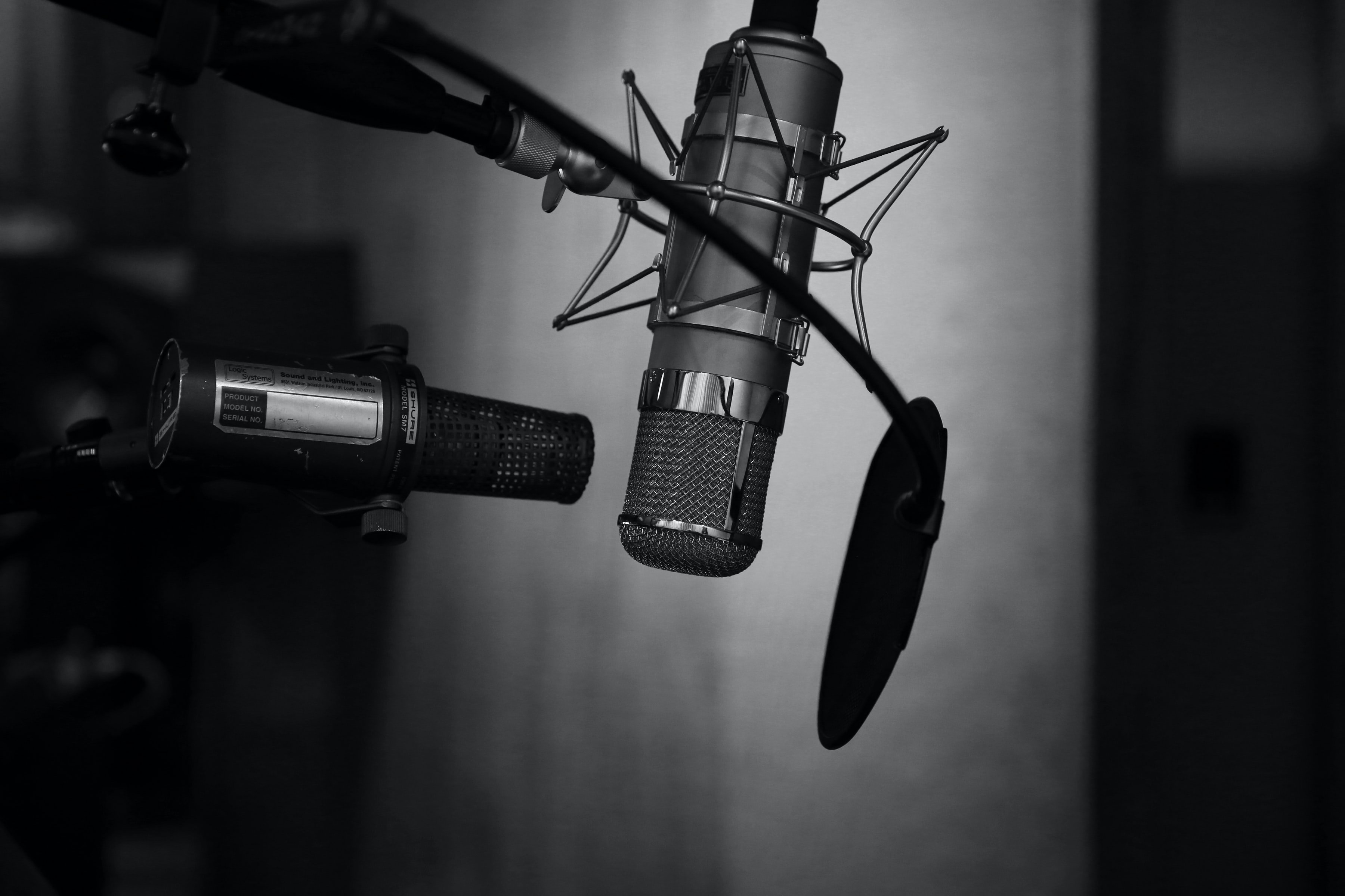 grayscale photo of a podcast setup by neil godding on Unsplash?width=698&height=466&fit=crop&auto=webp&dpr=4