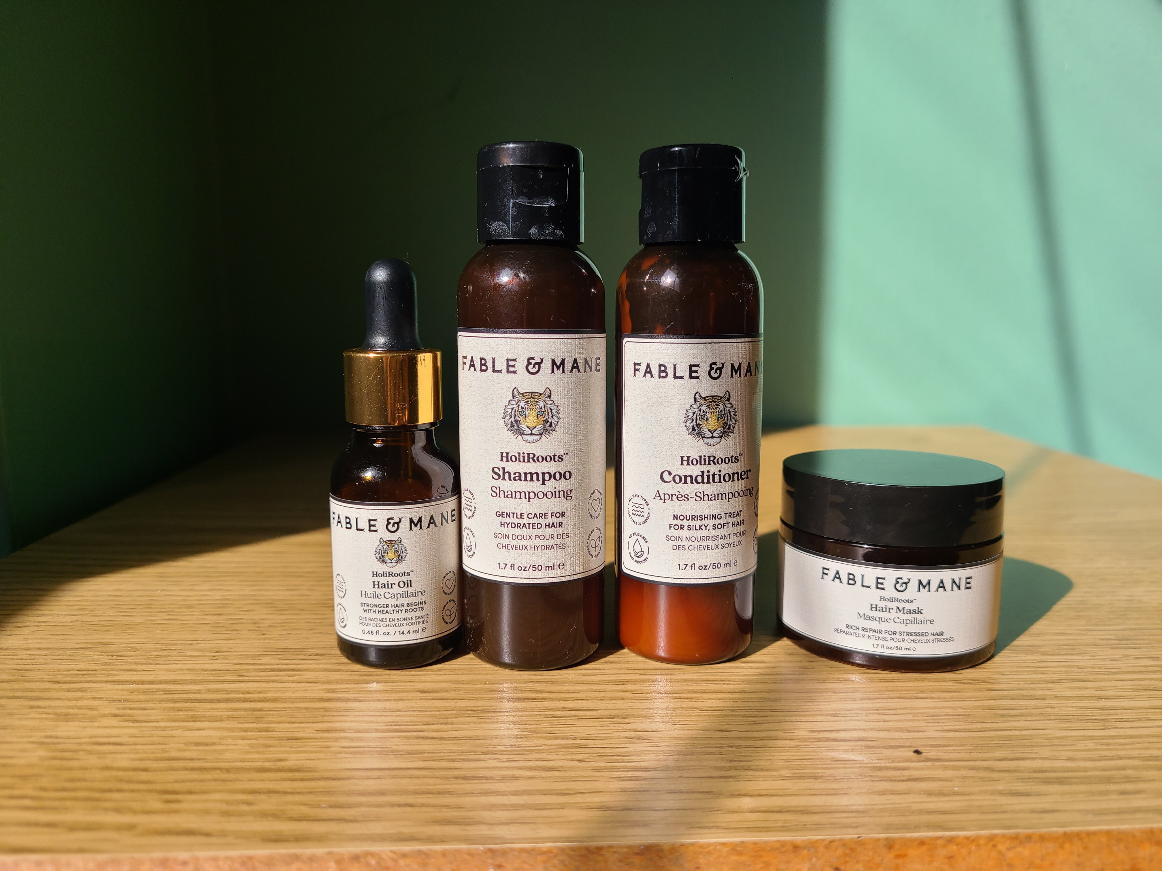 four Fable and Mane products on a wooden surface