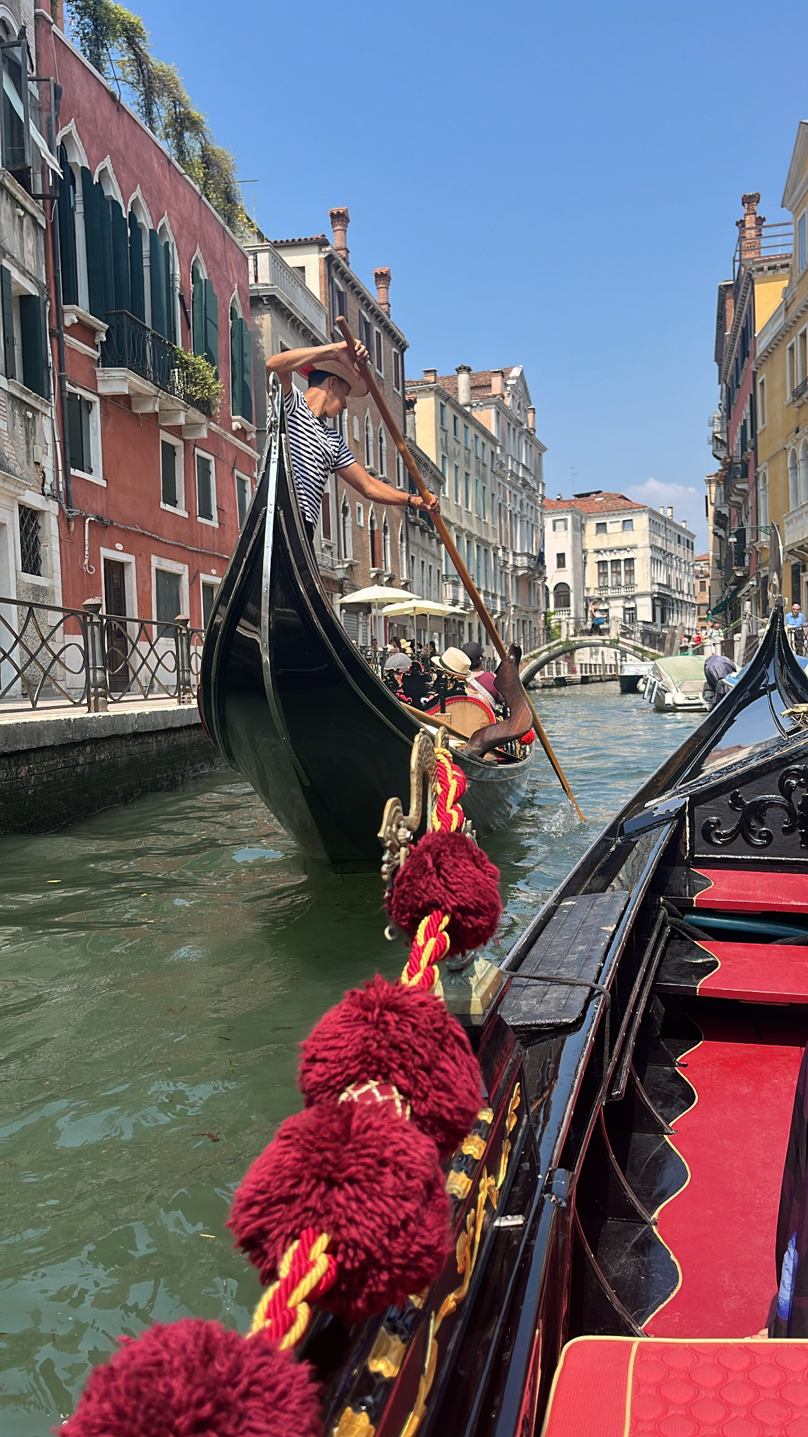 A gondola on the water with a man steering