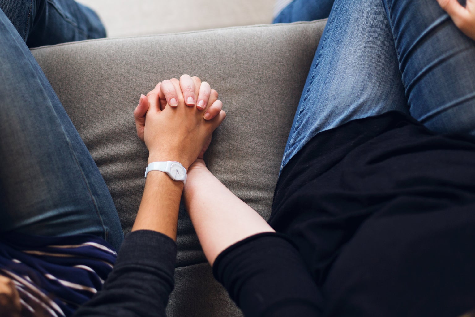 Two women holding hands