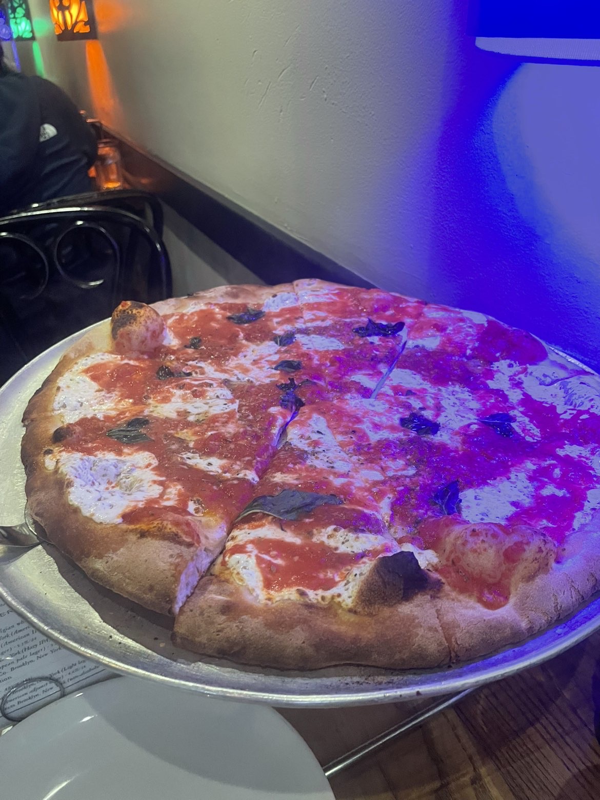 pizza on a tray in blue lighting