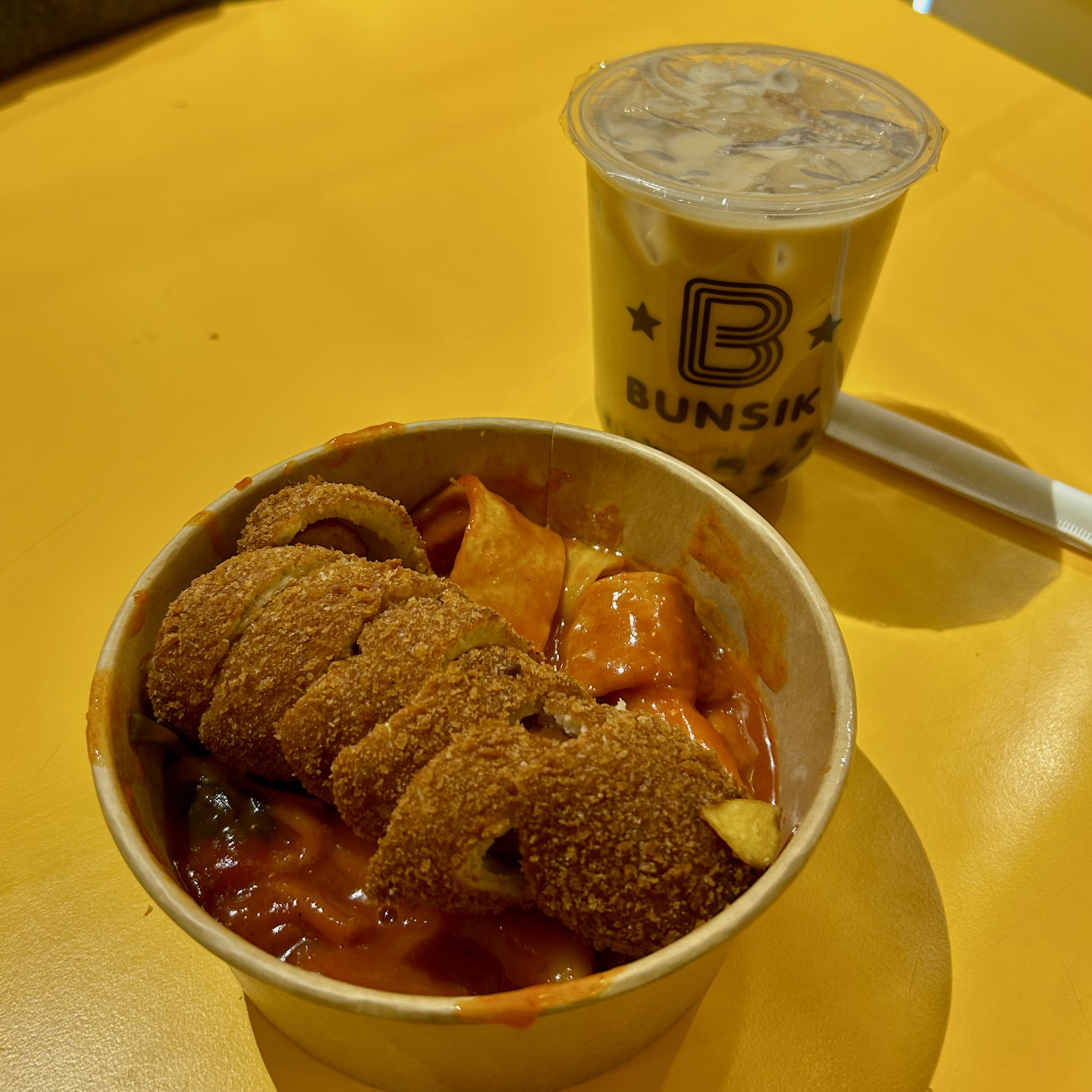 Korean street food on a yellow table