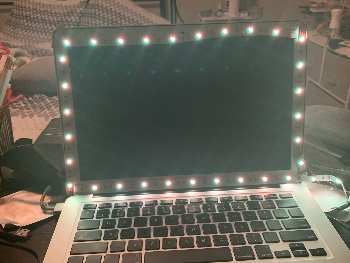 A laptop with LED lights around the screen