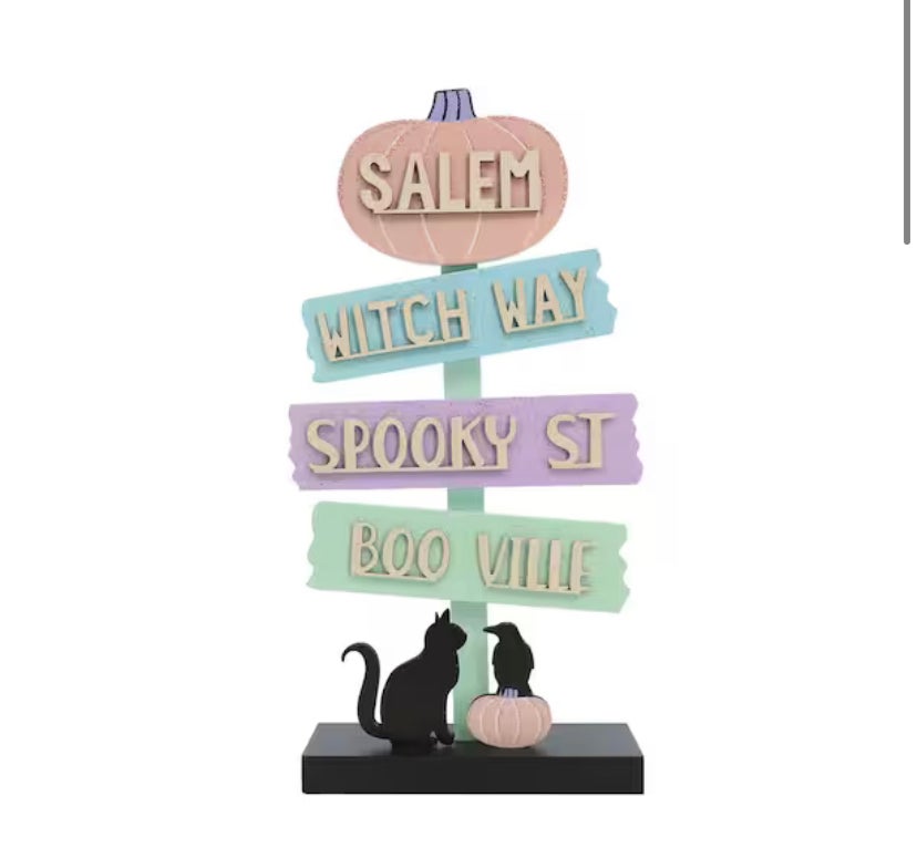 Halloween sign with arrows and town names