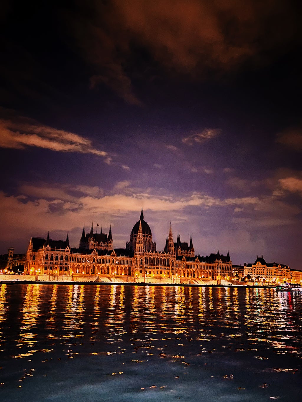 A castle at night in Budapest, Hungary looking over the Danube River.