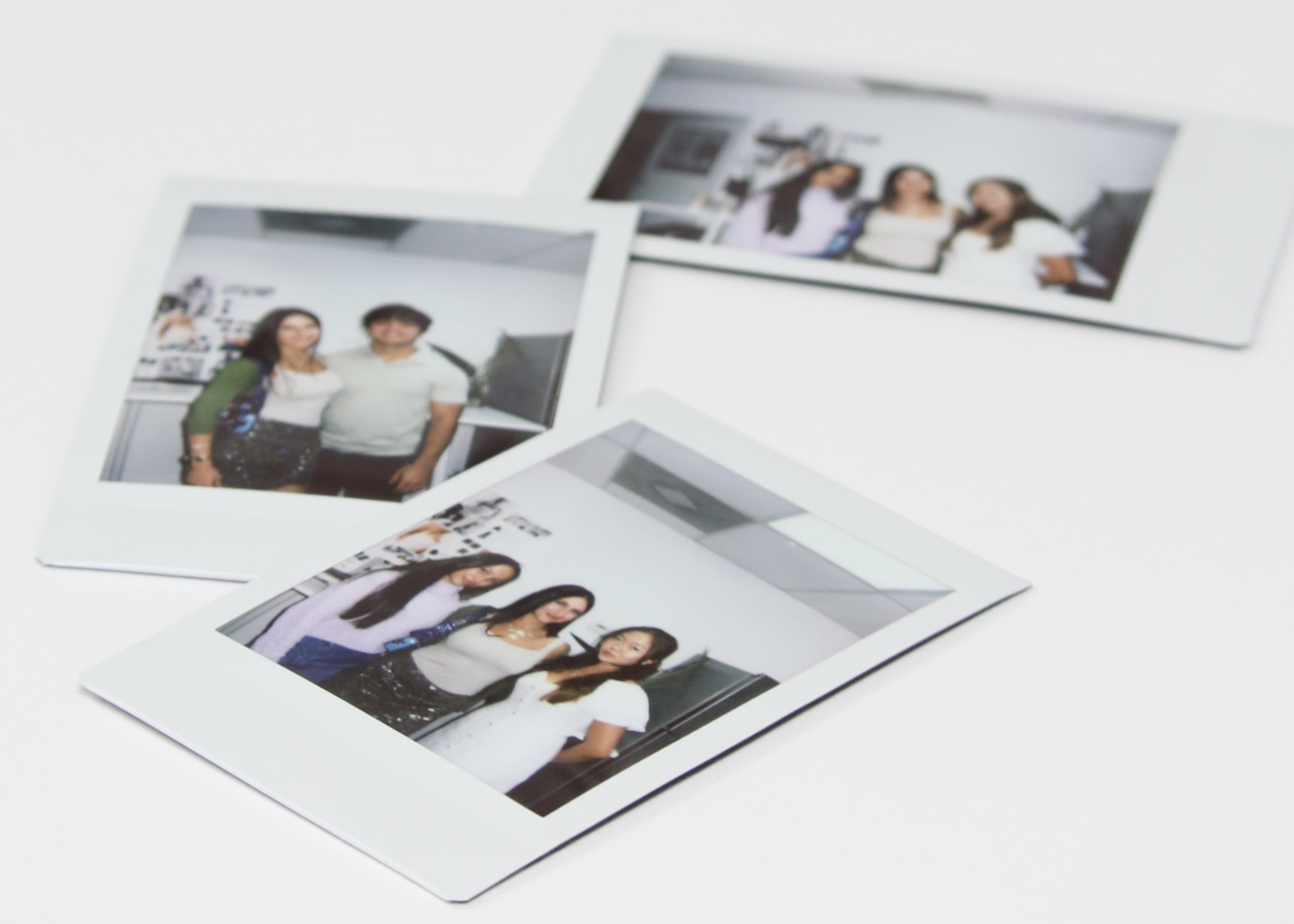 3 polaroids on a white table