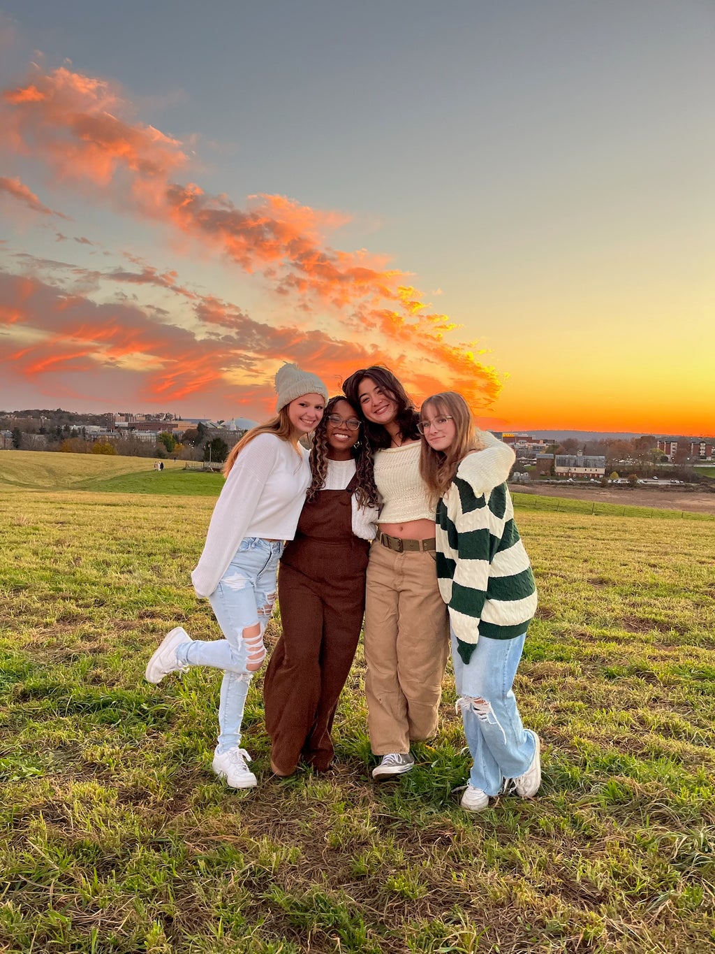 Girls smiling behind a sunset
