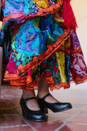 woman in traditional mexican dress and dancing shoes
