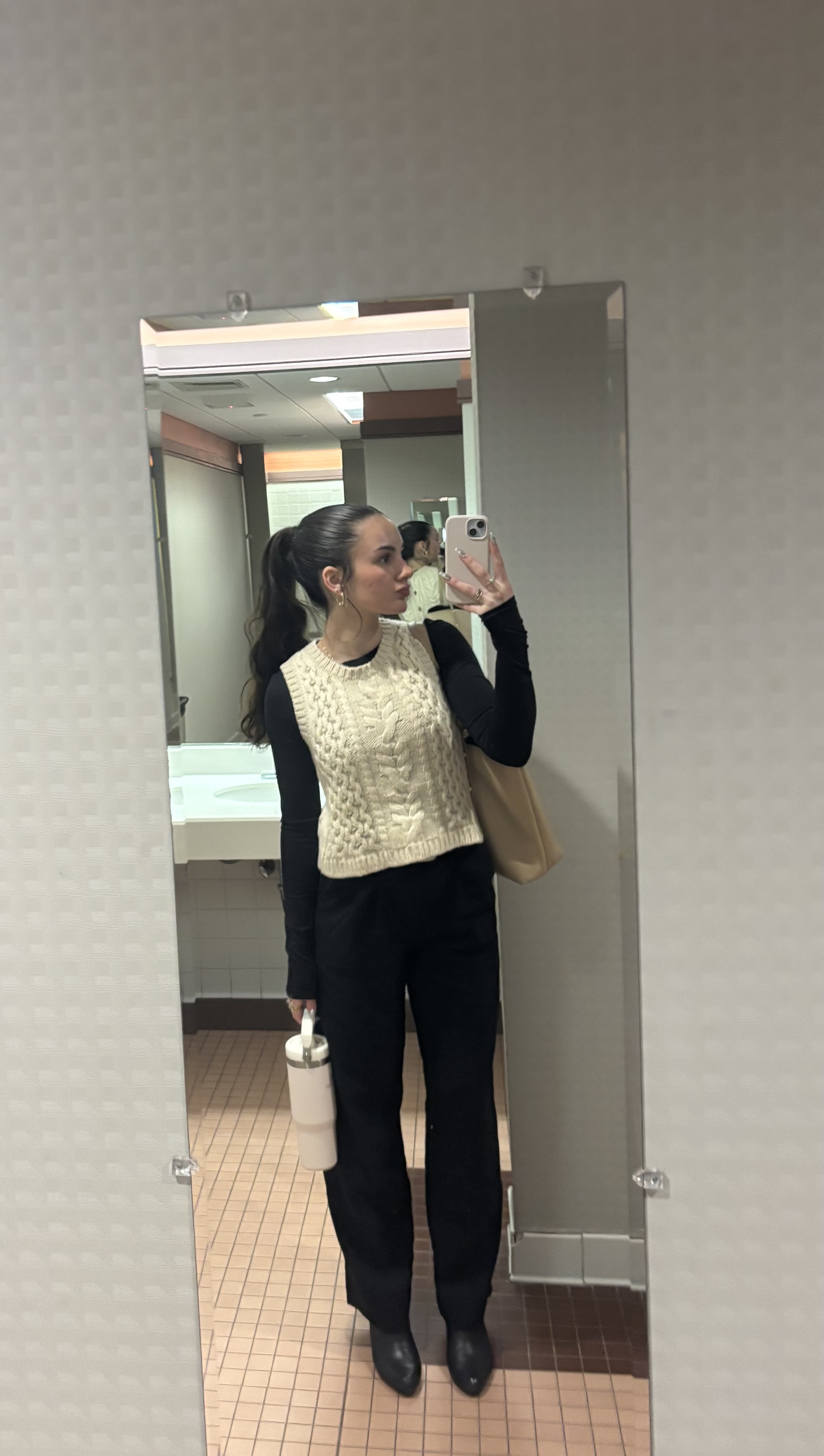 Girl posing in front of mirror taking picture of self