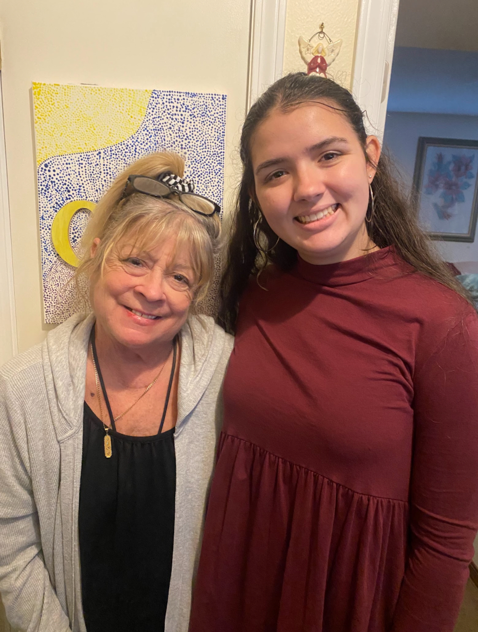 Grandmother standing smiling with grandaughter