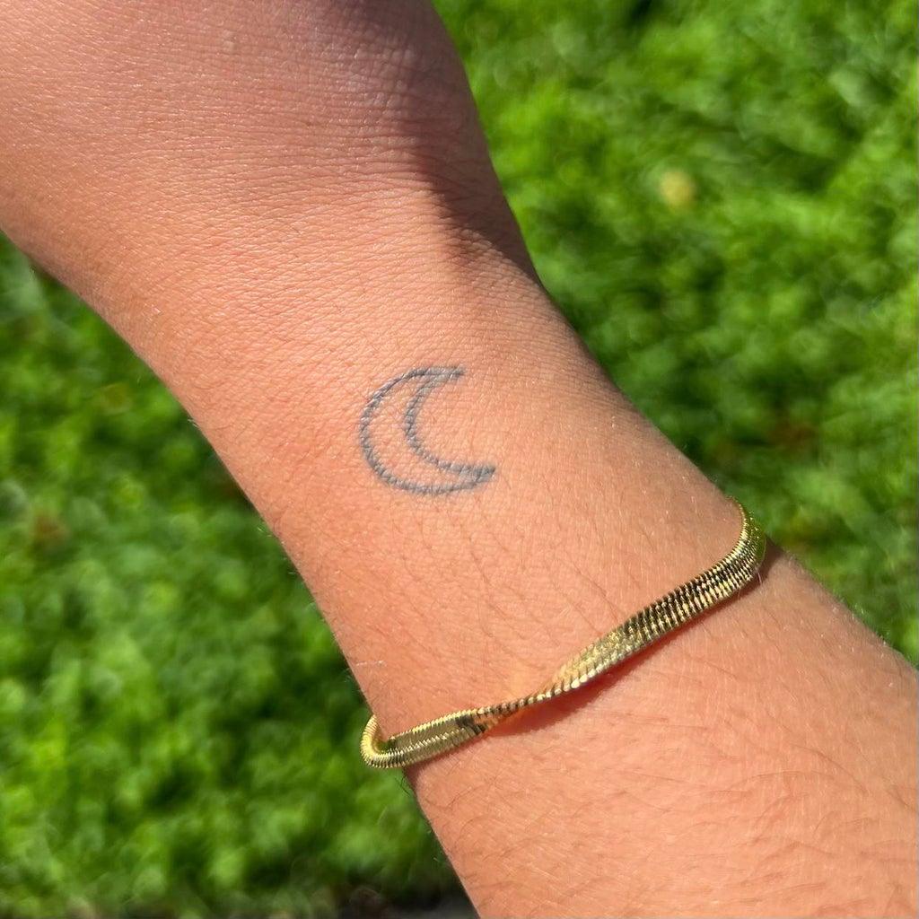 tattoo of moon on arm