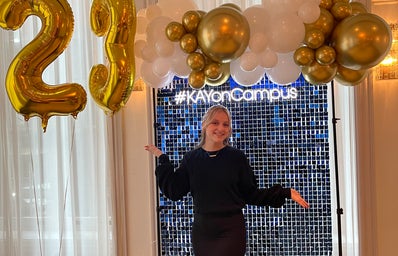 One of our Her Campus at Pace seniors standing in front of the \"#KAYonCampus\" sign