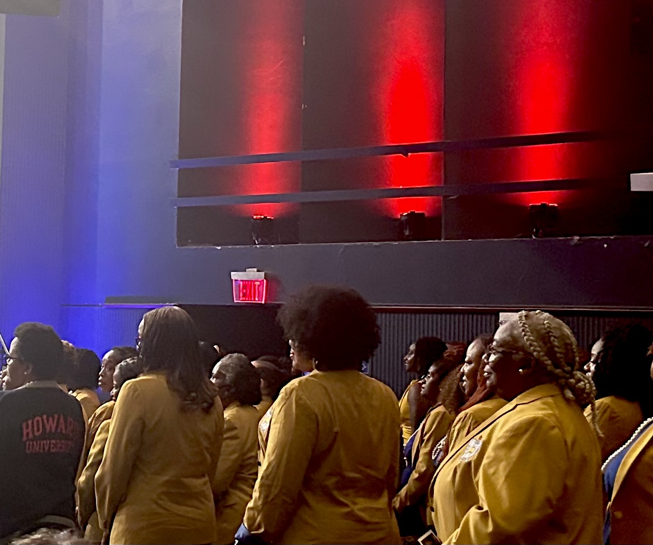 Sigma Gamma Rho members stand to be recognized and celebrated by audience attendees.