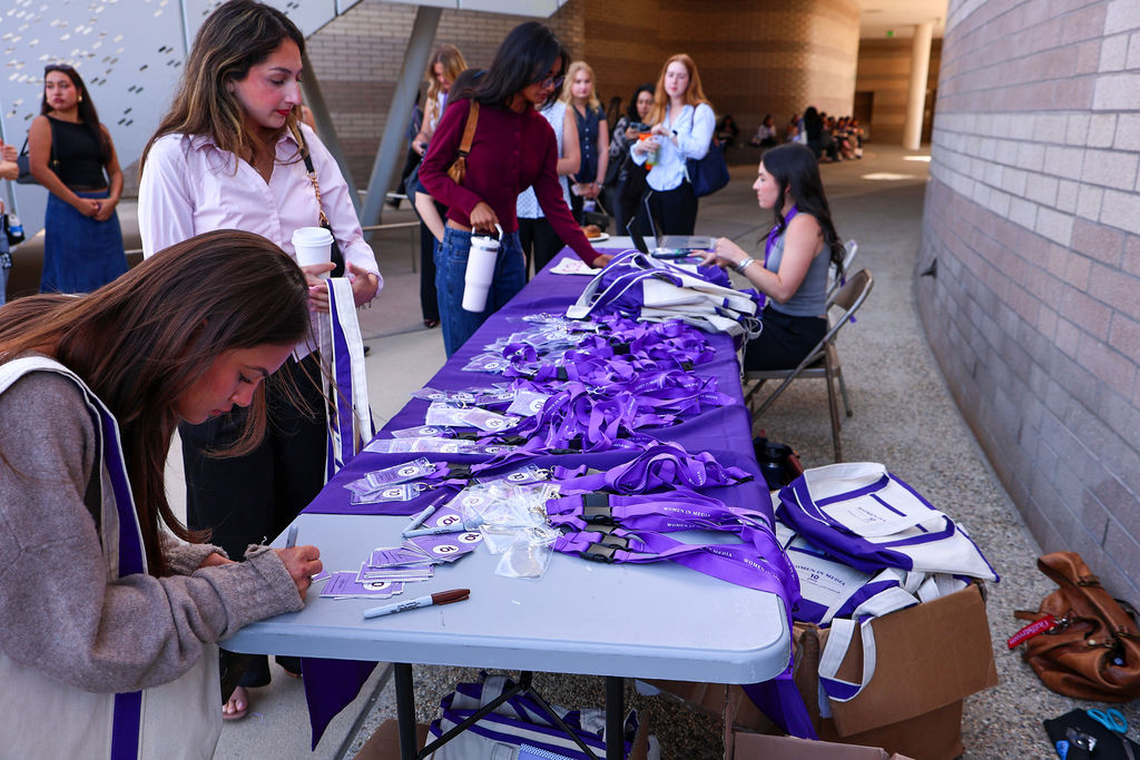 students checking into event