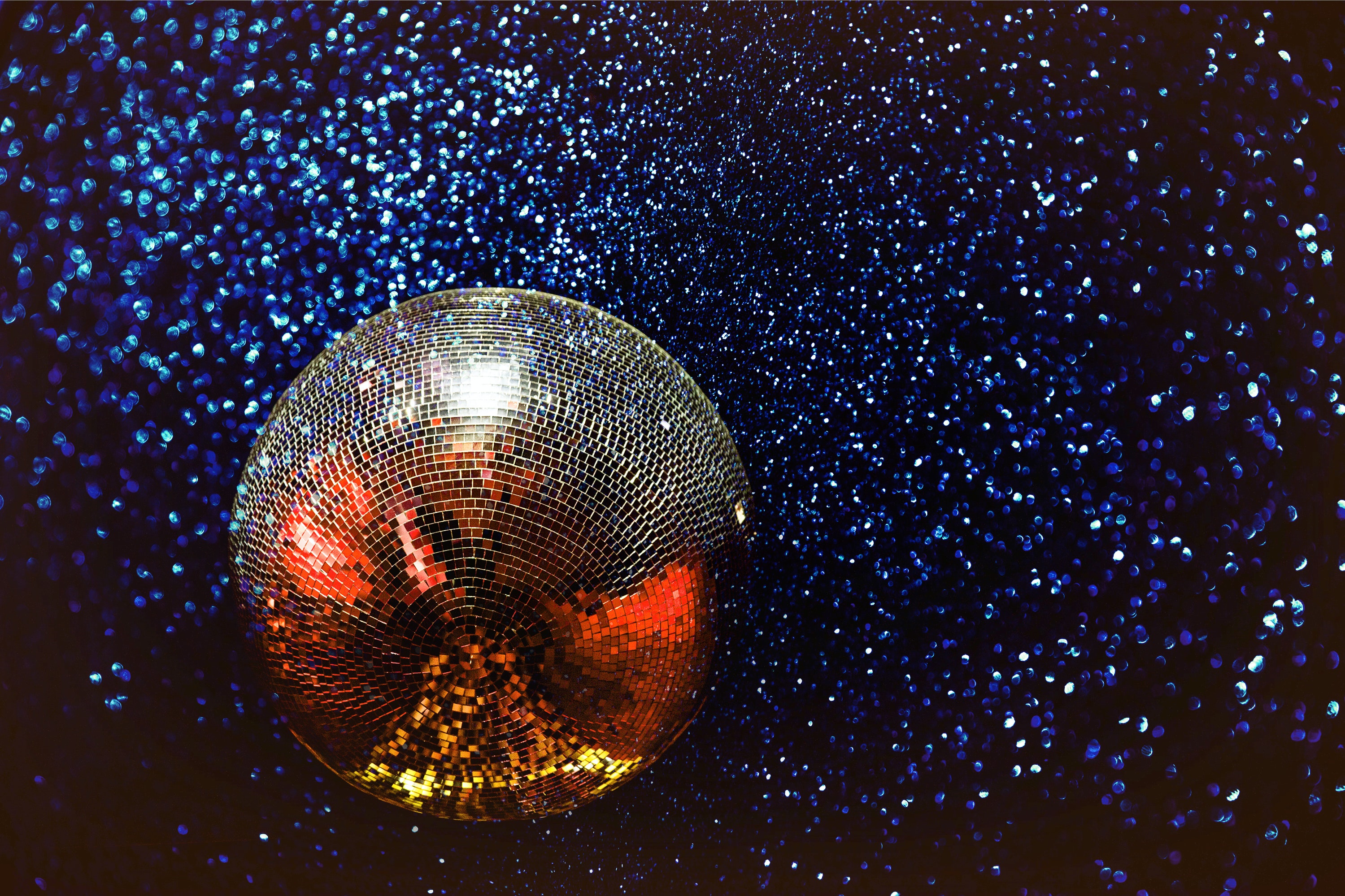 \"silver disco ball on blue glitter\"