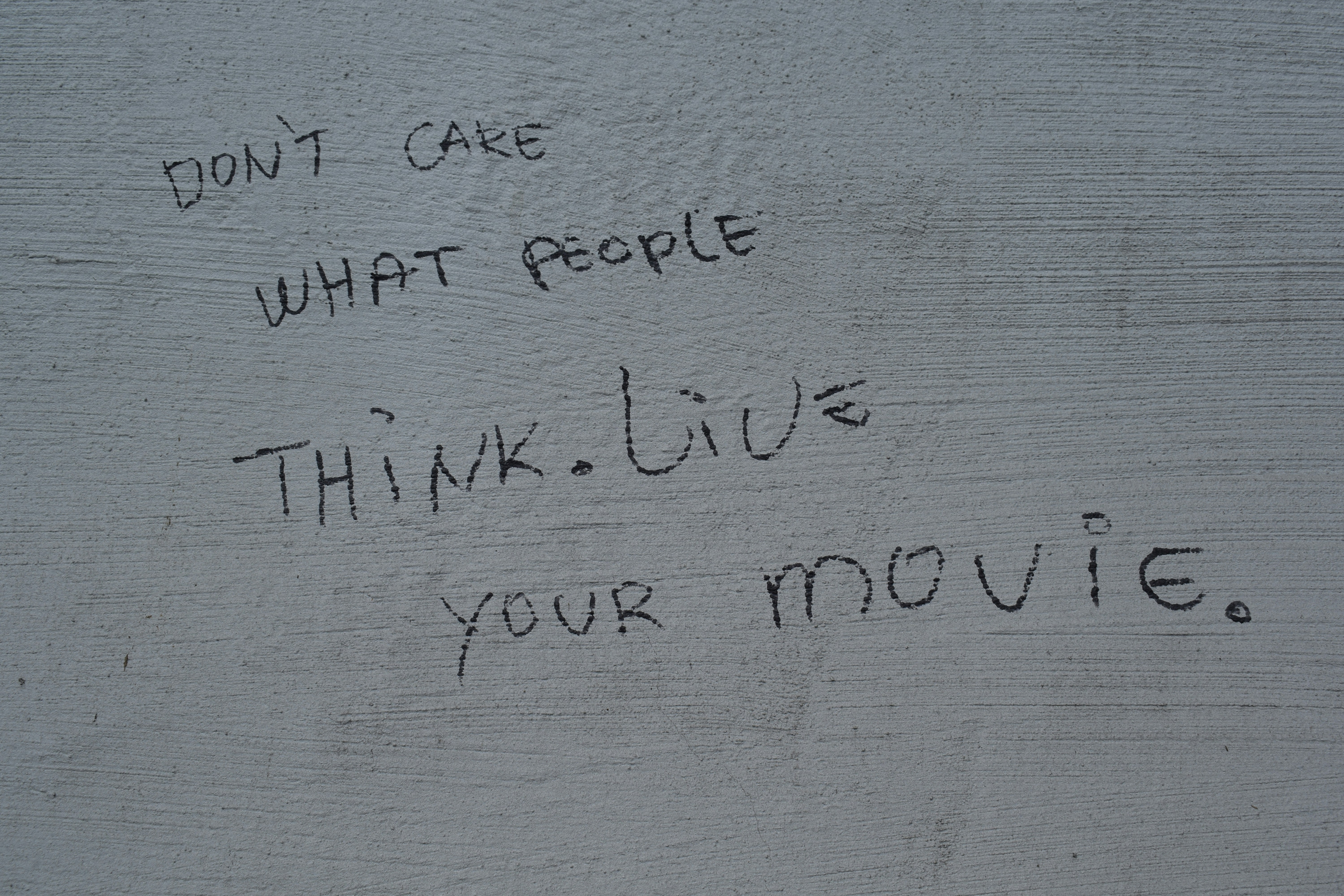 \"don\'t care what people think. live your movie\" in written script.