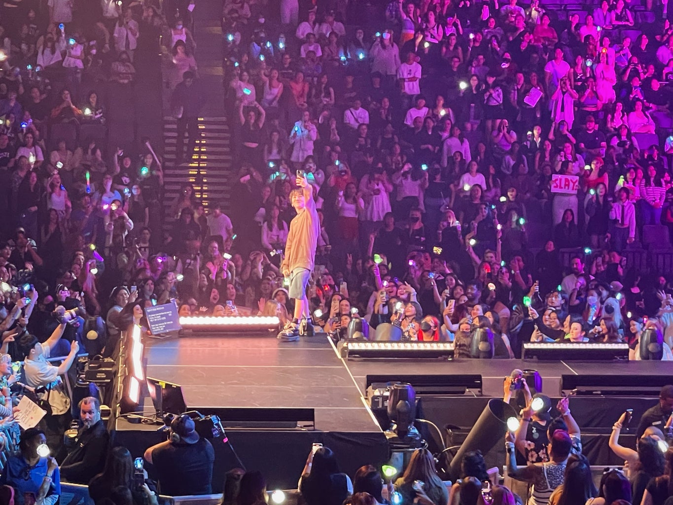 k-pop singer on stage taking selfie with fans