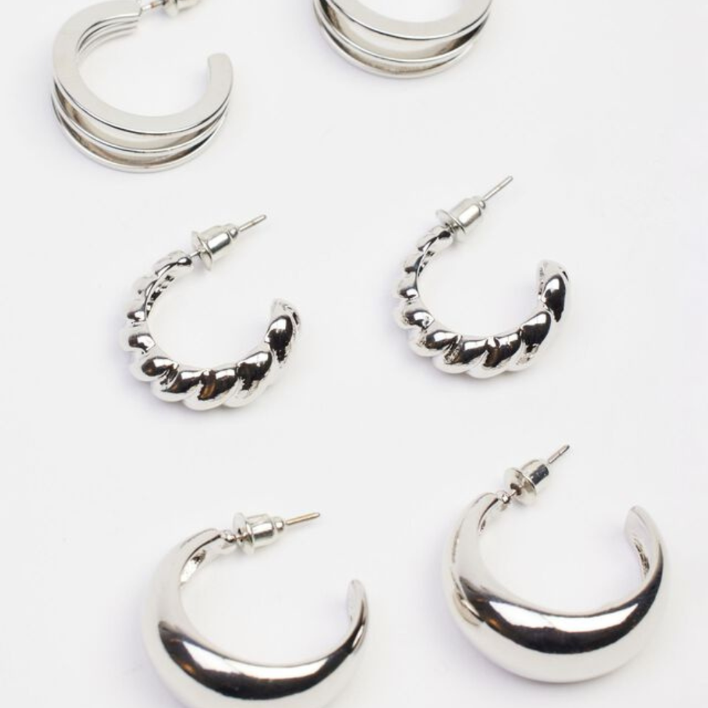 three pairs of silver hoop earrings