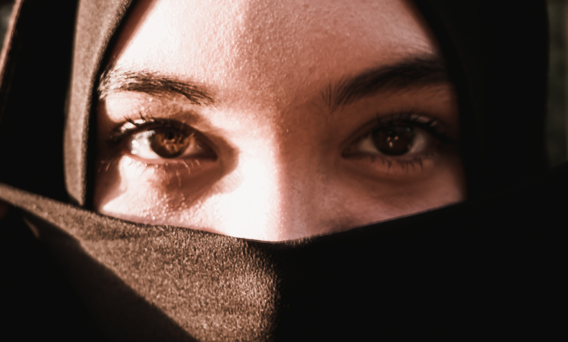 Young woman wearing black niqab.