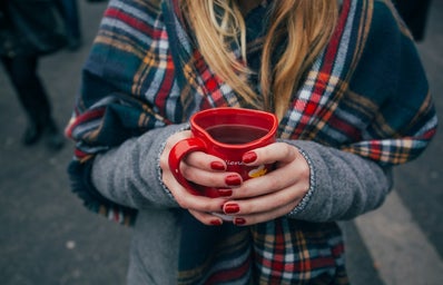 Woman holding coffee mug.