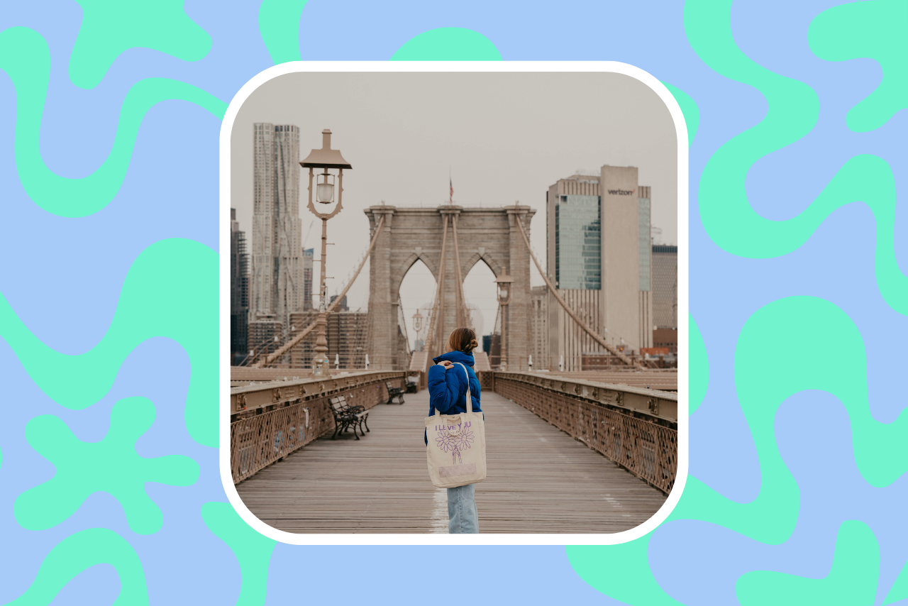 woman in 20s standing on city bridge