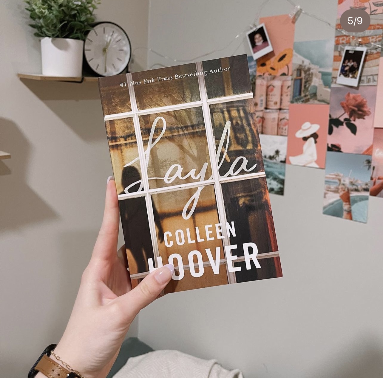 Hand holding book. Layla