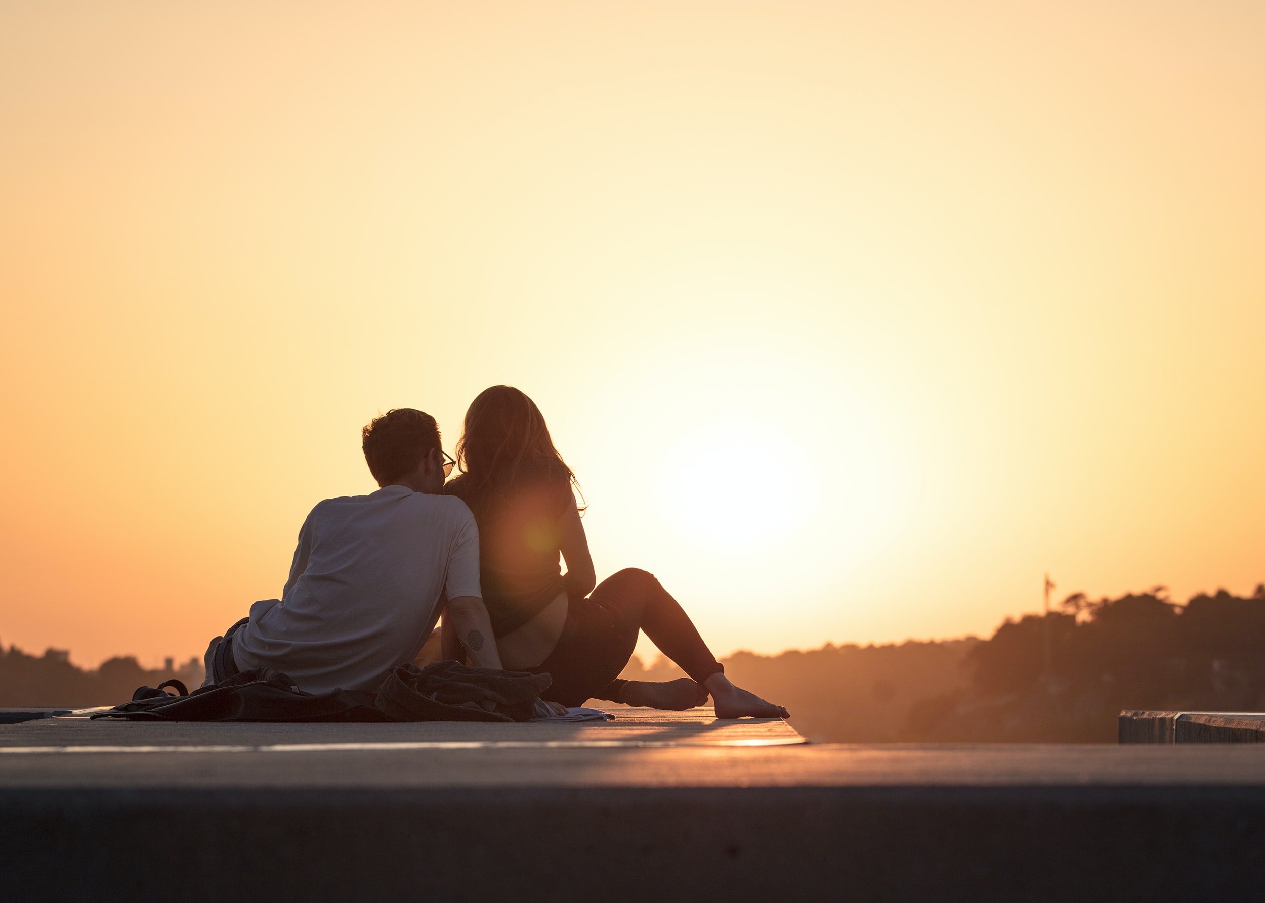 couple watching sunset by Khamko Vilaysing?width=698&height=466&fit=crop&auto=webp&dpr=4