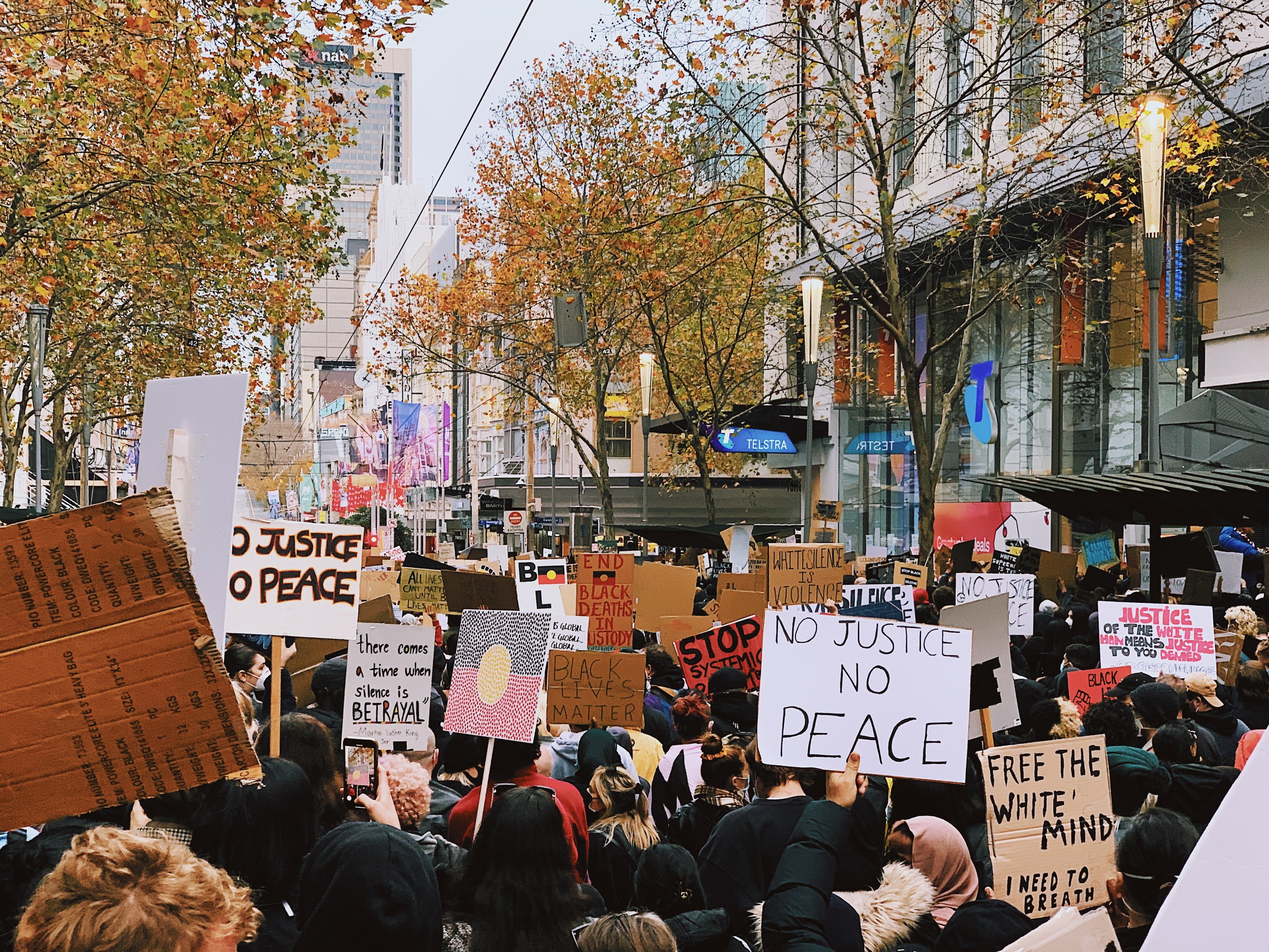 people standing on street during daytime with protest signs