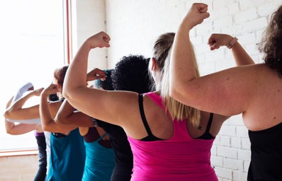 women flexing biceps