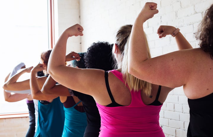 women flexing biceps