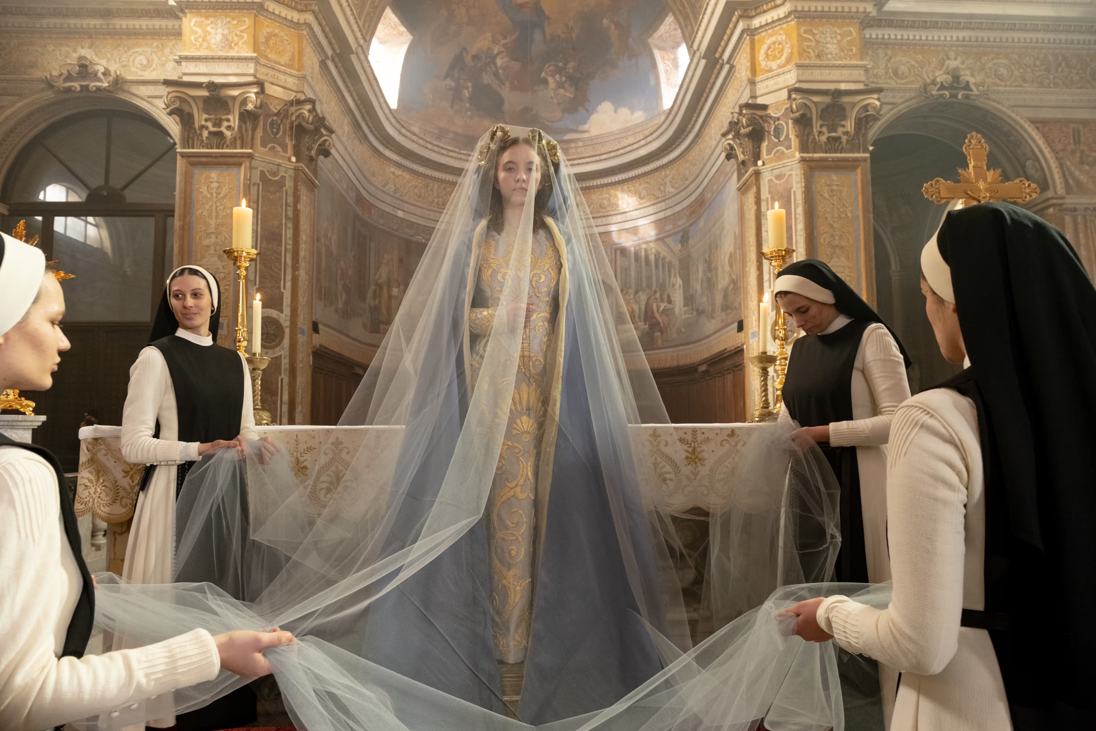 A woman (Sydney Sweeney) standing on an altar. Still image from Immaculate 2024.