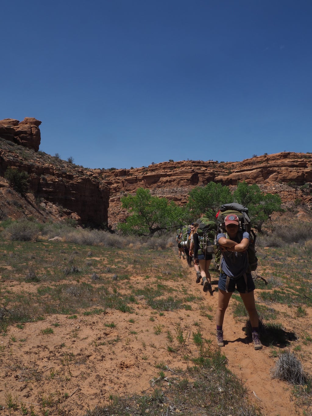 Backpacker standing cross armed in Utah wilderness