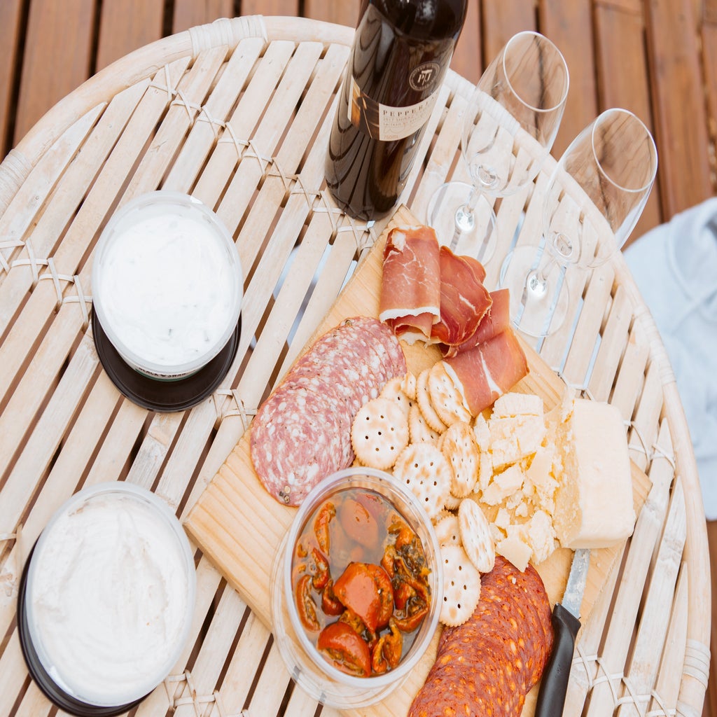 meats and biscuits tray beside wine glasses