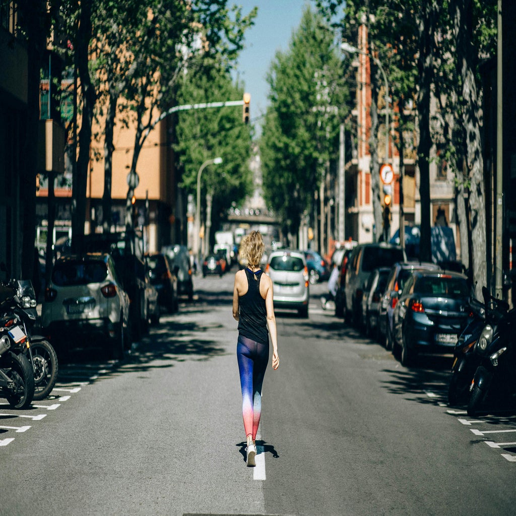 Woman walking in the middle of street.