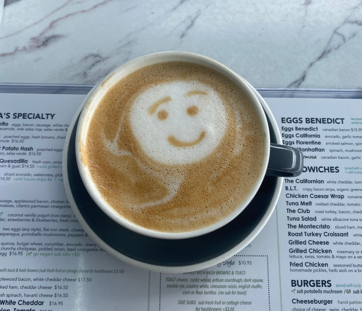 Cappuchino with a smiley face on top of menu