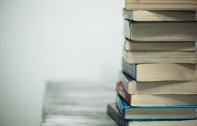 \"assorted books on wooden table\"