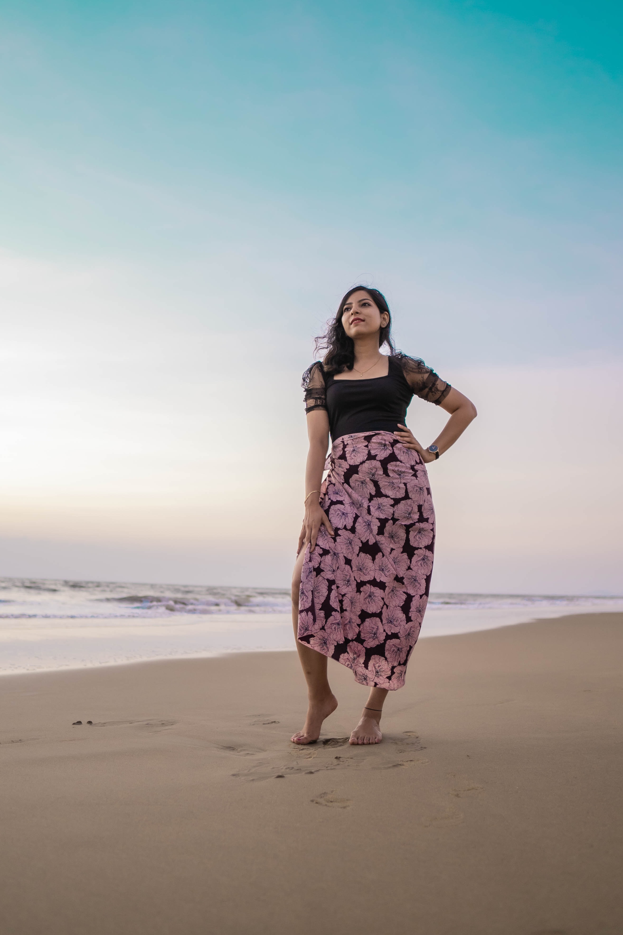 Woman standing with her hand on hip at the beach.