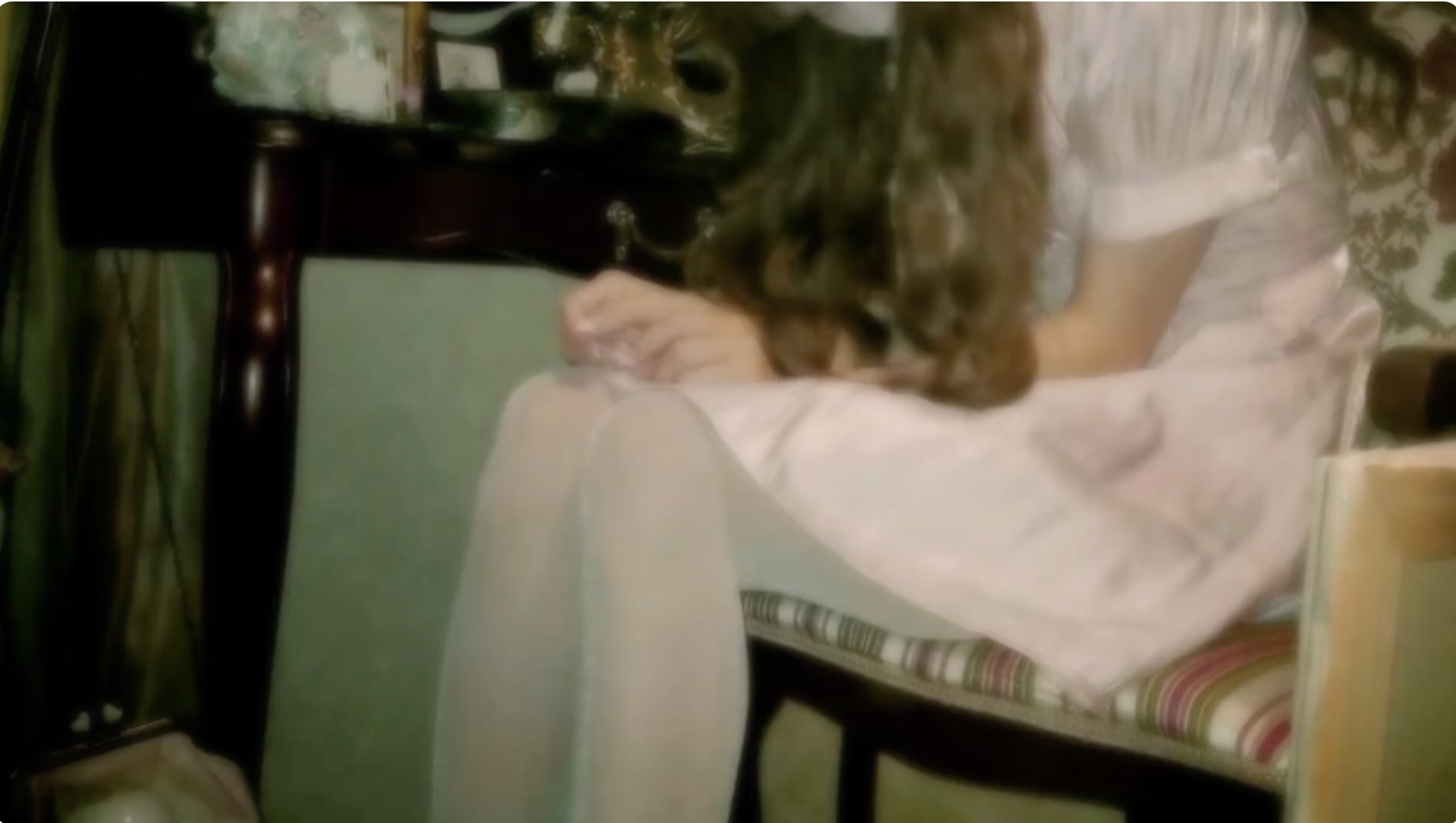 Ethel Cain woman sitting in chair sad