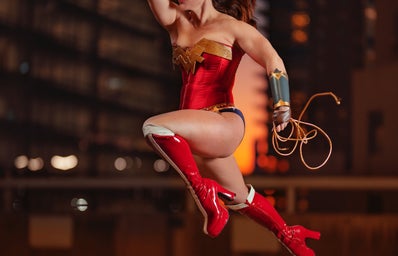 female superhero jumping with fist in the air