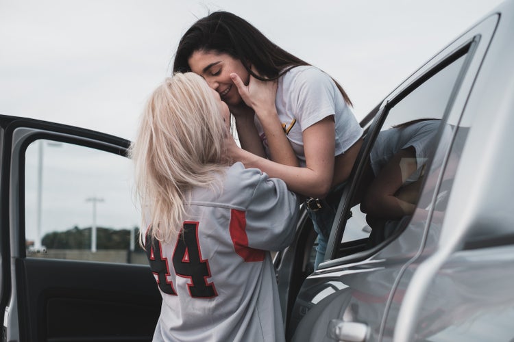 lgbtq+ couple kissing outside of car