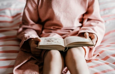 person reading book sitting