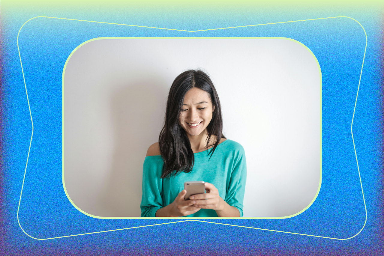 A young woman wearing a teal off-shoulder top smiles while looking at her phone, framed by a colorful blue and green gradient border.