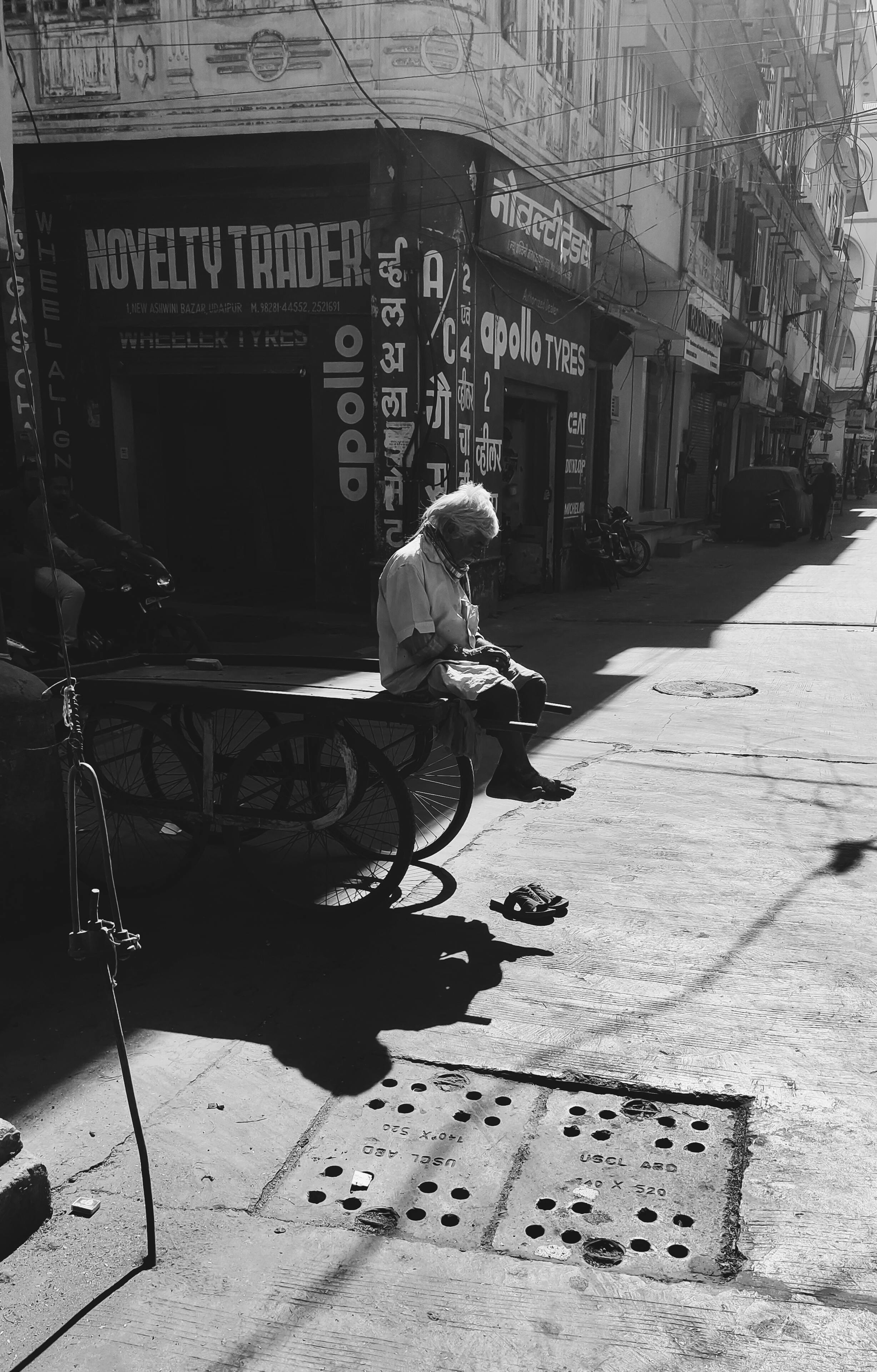 Elderly man sitting on a cart in India
